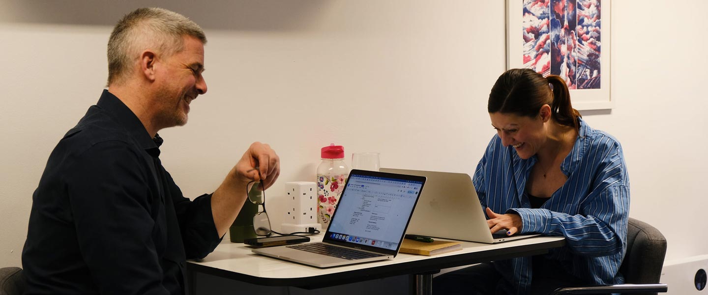 Account and operations managers reviewing client relationship management at desk