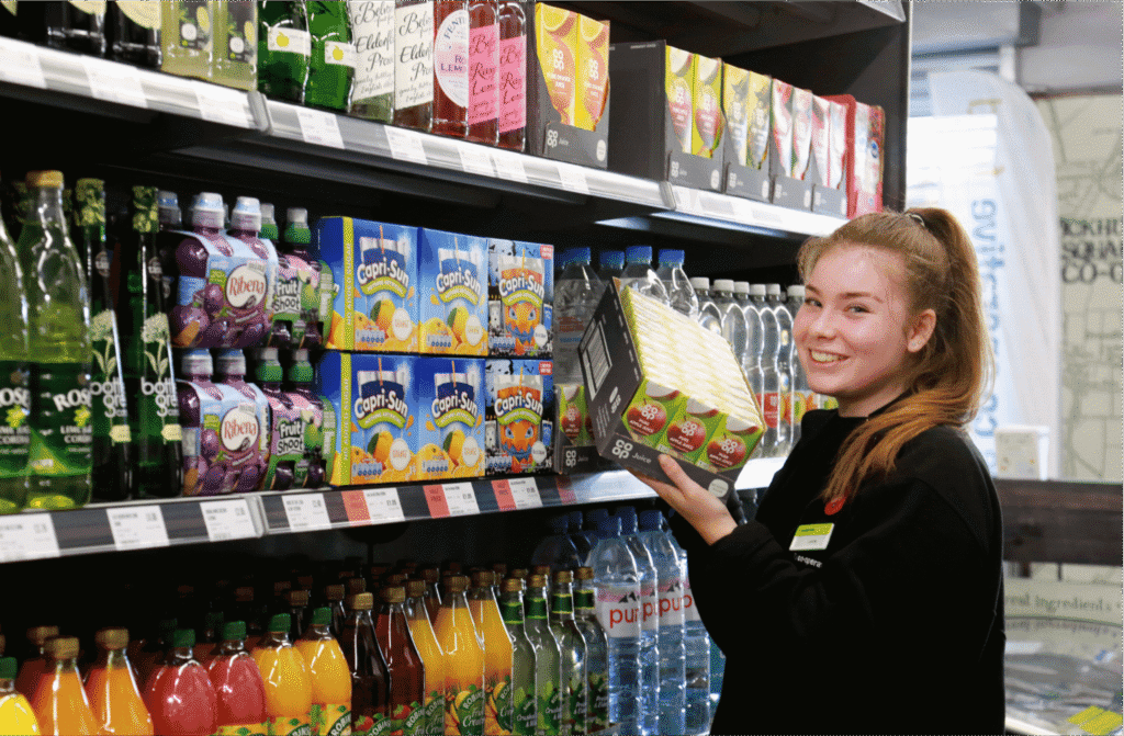 Southern Co-op staff stocking drinks supporting CRM customer relationship management and website design
