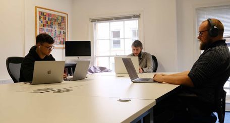 Developers collaborating on website development and CRM system integration for digital solutions